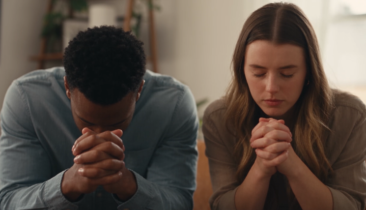 Two people praying together